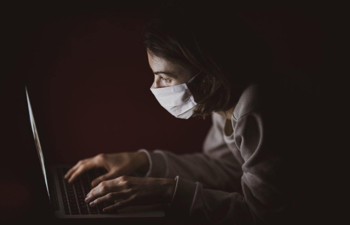 Image of a developer at a laptop wearing a facemask